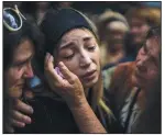  ?? (AP/Emilio Morenatti) ?? Anastasia Ohrimenko, 26, is comforted by relatives Aug. 31 as she cries next to the coffin of her husband, Yury Styglyuk, a Ukrainian serviceman who died in combat Aug. 24 in Maryinka, Donetsk, during his funeral in Bucha, Ukraine.