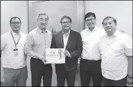  ??  ?? MTVI president and veteran author Melandrew Velasco presents the final draft of his latest book titled, ‘Kamagong: Antolin V. Paule, His Legacy and Lifetime Service with SM,’ to SM Prime Holdings chairman Hans Sy witnessed by the book primemover­s Junjun Abcede, Manny Sy and Angel Paul Galang.