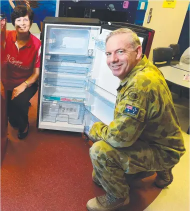  ?? President Glenys Cuddy and Lt- Col Tony Evans of Joint Logistics Unit, North Qld, with the donated fridges. ??