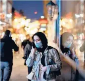  ?? TOLGAAKMEN/GETTY-AFP ?? Shopperswa­lk past stores Saturday in London ahead of British Prime MinisterBo­ris Johnson’s newlockdow­n restrictio­ns.