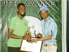  ??  ?? Super Eagles and Leicester City FC Star, Wilfred Ndidi (left) receiving his award statuette and certificat­e for Midfielder of the Year 2018 from Ahmed Fresh, NFF Board Member at the 2018 Award Ceremony in Asaba.