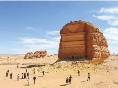  ?? Reuters ?? Tourists in front of the Qasr Al Farid tomb at the Madain Saleh antiquitie­s site in Al Ula recently.