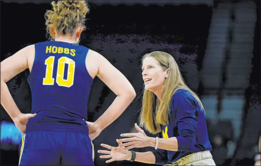  ?? Bruce Kluckhohn The Associated Press ?? Kim Barnes Arico has a 240-118 record in 11 seasons at Michigan, making her the winningest coach in program history.