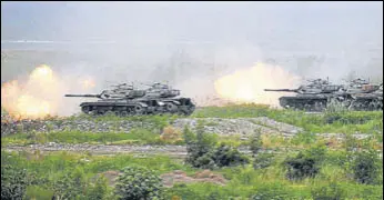  ?? BLOOMBERG ?? CM-34 Clouded Leopard armoured vehicles take part in a military exercise in Taiwan’s Taichung on Thursday. Taiwan held the drills as a stern message to China amid rising tensions.
