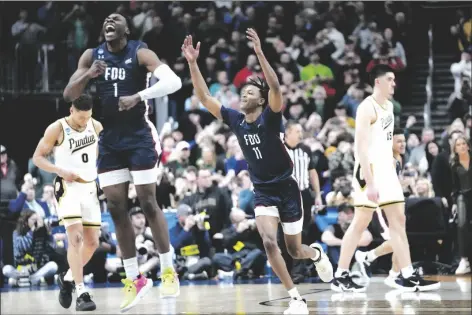  ?? PAUL SANCYA/AP ?? FAIRLEIGH DICKINSON GUARD JOE MUNDEN JR. (1) and Sean Moore (11) celebrate beating Purdue after a first-round game in the NCAA Tournament on Friday in Columbus, Ohio.