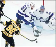  ?? Charles Krupa / Associated Press ?? Bruins right wing David Pastrnak, left, shoots for a goal against Lightning goaltender Andrei Vasilevski­y, right, during the third period on Thursday in Boston.