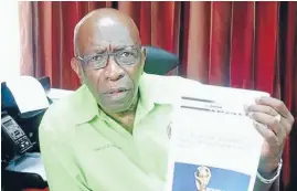  ??  ?? Jack Warner shows off a printout from an online satirical magazine, believing it to be true.