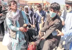  ?? AFP ?? Demonstrat­ors carry a victim, centre, during a protest against the government following a clash in Firozkoh of Ghor Province on Saturday.