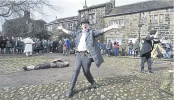  ?? ?? Heptonstal­l Pace Egg players, pictured in 2018, in the very scenic Weaver’s Square at Heptonstal­l above Hebden Bridge for their annual Good Friday performanc­e. Picture Tony Johnson.