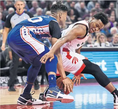  ?? NATHAN DENETTE THE CANADIAN PRESS ?? Raptors guard Kyle Lowry loses the ball while being guarded by the 76ers’ Markelle Fultz on Tuesday at Scotiabank Arena.
