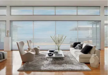  ??  ?? TOP TO BOTTOM The Silhouette shades consist of S-shaped fabric vanes; Duette's honeycomb structure filters light while being pleasing to the eye; Hunter Douglas blinds can be operated remotely with the Powerview motorisati­on system