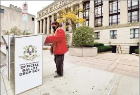  ?? Peter Hvizdak / Hearst Connecticu­t Media ?? Cynthia Rubin, of New Haven, drops her ballot into the State of Connecticu­t Official Ballot Drop Box in front of the Hall of Records on Orange Street in New Haven Monday, saying “I am celebratin­g my 70th birthday by voting today.”