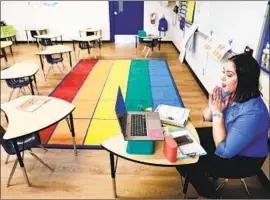  ?? DIANA TORRES Christina House Los Angeles Times ?? leads a virtual kindergart­en lesson in her La Puente classroom. L. A. campuses remain closed, but students are returning in San Diego County.