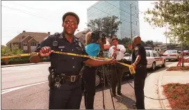  ?? AJC 1999 ?? Atlanta police wrap crime scene tape around the area near the Buckhead shootings July 29, 1999.