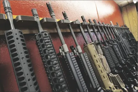  ?? ALEX BRANDON/AP ?? A row of rifles for sale is on display at a gun shop in Aurora, Colo., on July 20, 2012. The mass shooting in Buffalo, N.Y., has prompted questions about the effectiven­ess of “red flag laws” passed in 19 states and the District of Columbia.