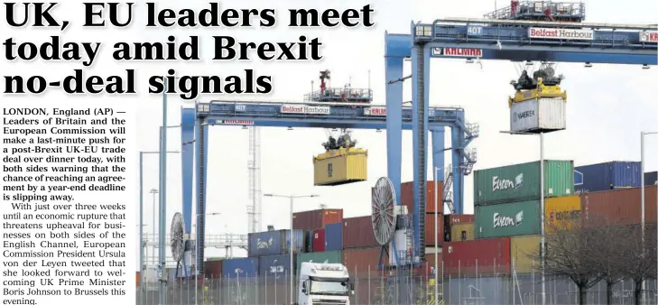  ?? (Photo: AP) ?? Shipping containers are lifted to be transporte­d at Belfast Harbour in Northern Ireland, yesterday. Britain and the European Union solved one thorny problem in their divorce, the status of Northern Ireland, but warned that the chances of a post-brexit trade deal by a year-end deadline is slipping away. Britain is due to leave the EU’S economic structures on January 1.