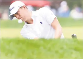  ?? Peter Hvizdak / Hearst Connecticu­t Media ?? Justin Thomas punches a shot onto the ninth green during the second round of the Travelers Championsh­ip on Friday.