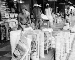  ?? ?? Workers repack their rice products for sale at the Pasig City Mega Market.