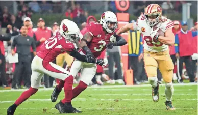  ?? ROB SCHUMACHER/USA TODAY SPORTS ?? 49ers tight end George Kittle (85) runs past Cardinals Budda Baker (3) and Marco Wilson on his way to a touchdown after his reception during the second quarter on Monday night at Estadio Azteca in Mexico City.