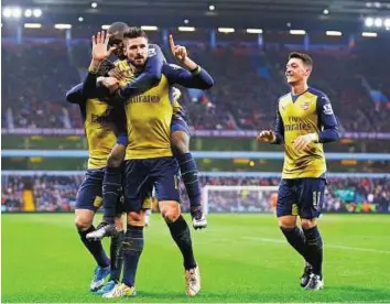  ?? Reuters ?? The hitman Olivier Giroud celebrates with teammates after scoring the first goal for Arsenal from the penalty spot during their Premier League match against Aston Villa at Villa Park yesterday.