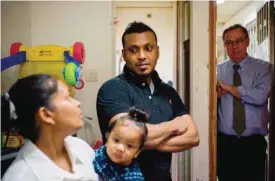  ??  ?? HONG KONG: Supun Thilina Kellapatha (center) and his partner Nadeeka holding their baby boy Danath, Sri Lankan refugees who helped shelter fugitive whistleblo­wer Edward Snowden in 2013, speak as their lawyer Robert Tibbo (right) listens in their flat in Hong Kong. — AFP