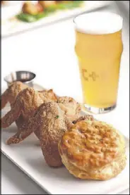  ?? CONTRIBUTE­D BY CHUCKY KAHNG ?? Wings with hot sauce and a molasses biscuit at Chicken + Beer.