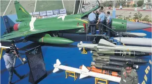  ??  ?? Delegate members look at Pakistan’s JF-17 Thunder multirole combat aircraf during the Internatio­nal Defence Exhibition and Seminar (IDEAS) in Karachi on November 23, 2016.