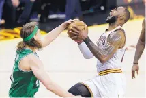  ?? TONY DEJAK/ASSOCIATED PRESS ?? Boston’s Kelly Olynyk strips Cleveland’s LeBron James as James goes up for a shot. But James scored 34 in the Cavs’ win.