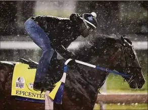  ?? Charlie Riedel / Associated Press ?? Kentucky Derby entrant Epicenter works out in the rain Tuesday at Churchill Downs in Louisville, Ky. The early 7-2 second choice for Saturday’s Kentucky Derby won his first career race at Churchill Downs this past fall.