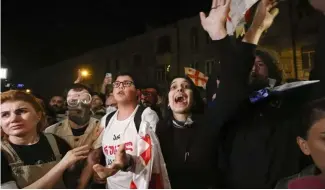  ?? ?? Demonstrat­or shouts during a rally outside the parliament building in Tbilisi, Georgia, on Thursday, April 18, 2024, to protest against "the Russian law"