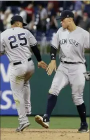  ?? MATT SLOCUM — THE ASSOCIATED PRESS ?? The New York Yankees’ Gleyber Torres, left, and Aaron Judge celebrate after a baseball game against the Philadelph­ia Phillies, Monday, in Philadelph­ia. New York won 4-2.