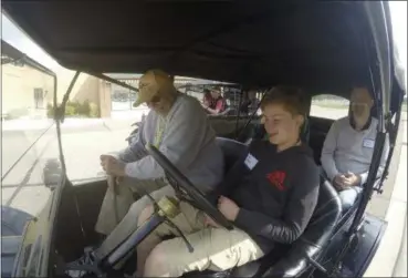  ?? MIKE HOUSEHOLDE­R — THE ASSOCIATED PRESS ?? Alan Bennett, sitting behind the wheel, listens as 92-year-old instructor Jim Brand provides guidance on how to drive the Model T at the Gilmore Car Museum in Hickory Corners, Mich. Bennett, who is 12, is among the more than 500 people this year who...