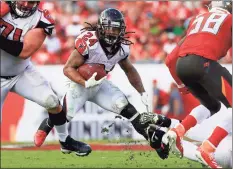  ?? Mike Ehrmann / TNS ?? Devonta Freeman, seen here playing for the Falcons in December, signed with the Giants on Tuesday, and the veteran running back could practice with the team as early as Wednesday.