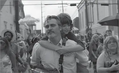  ?? A24 ?? JOAQUIN PHOENIX as Johnny, left, and Woody Norman as his nephew Jesse in “C’mon C’mon,” directed by Mike Mills.