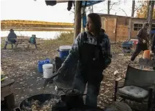  ?? ?? ‘NOBODY HAS FISH’: Giovanna Stevens cooks breakfast for a hunting party along the Yukon River on Sept. 15 near Stevens Village, Alaska.