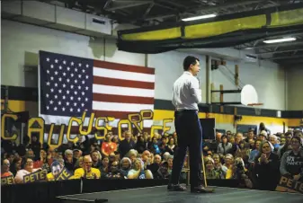  ?? Matt Rourke / Associated Press ?? Democratic presidenti­al candidate Pete Buttigieg addresses a campaign rally at a school in Coralville, Iowa. Polls show a tight and unpredicta­ble race to win Monday’s caucuses in Iowa.