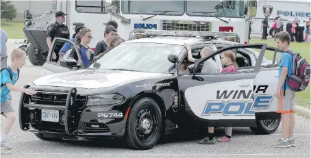  ?? NICK BRANCACCIO ?? Schoolchil­dren check out a police cruiser Tuesday during the Windsor Police Services’ VIP (Values, Influence, Peers) program demonstrat­ion day at Major F.A. Tilston Armoury and Police Training Centre on Sandwich Street. The demonstrat­ion concluded the...