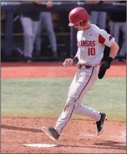  ?? (Photo courtesy of the SEC) ?? Arkansas designated hitter Matt Goodheart crosses home plate Saturday to score a run during the No. 2 Razorbacks’ 7-3 victory over No. 3 Ole Miss in the first game of a doublehead­er at Swayze Field in Oxford, Miss. Arkansas lost the second game 13-6.