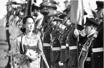  ?? — AFP photo ?? Suu Kyi receives an official welcome on the forecourt during her visit to Parliament House in Canberra.