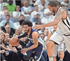  ?? ERIC GAY / AP ?? Grizzlies guard Mike Conley (11) drives around San Antonio forward LaMarcus Aldridge (12) during Game 1ofa first-round NBA playoff series on Saturday in San Antonio.