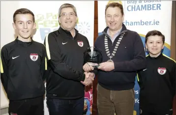  ??  ?? Joe Walker, chairman Grant Walker and Daniel Walker from Ardmore Rover being presented with the award for Best Sports Entry by Pat Ó Suillebhai­n, Vice President of Bray Chamber.