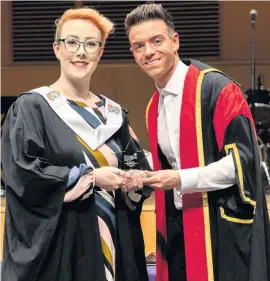  ?? ?? In the spotlight Julie Savage receives her academic excellence award from guest speaker, comedian and radio presenter Des Clarke