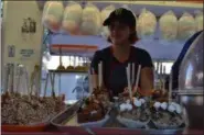  ?? MORNING JOURNAL FILE ?? Marina Lallathin sold caramel apples at the Elyria Apple Festival.
