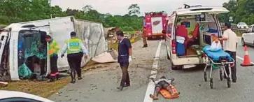  ?? PIC COURTESY OF POLICE ?? The two men who allegedly stole a lorry being taken to a hospital in Temerloh after a crash at Km114 of the East Coast Highway yesterday.