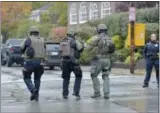  ?? PAM PANCHAK—ASSOCIATED PRESS ?? Polikce respond to an active shooter situation at the Tree of Life synagogue on Wildins Avenue in the Squirrel Hill neighborho­od of Pittsburgh, Pa., on Saturday, October 27, 2018.