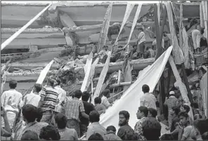  ?? AP/A.M. AHAD ?? Rescuers use fabric from a collapsed garment factory building to get survivors down Wednesday in Savar, Bangladesh.