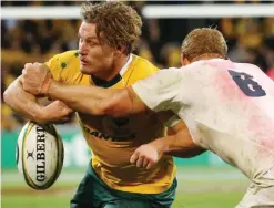  ??  ?? Australia’s Michael Hooper has the ball knocked from his grasp by England’s Chris Robshaw.