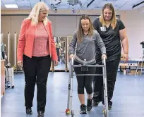  ?? TOM FOUGEROUSS­E/UNIVERSITY OF LOUISVILLE VIA AP ?? Professor Susan Harkema watches May 22 as Kelly Thomas of Lecanto, Fla., practices walking a walker. Harkema co-authored a report on the use of electrical implants to stimulate the spinal cord.