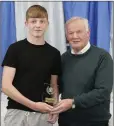  ??  ?? Ben Robinson accepts the under-15 Player of the Year award from President John Byrne.