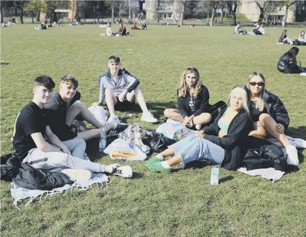  ??  ?? 0 People enjoying a welcome dose of sunshine in the Meadows yesterday on the first day of movement and gathering following relaxation of lockdown rules